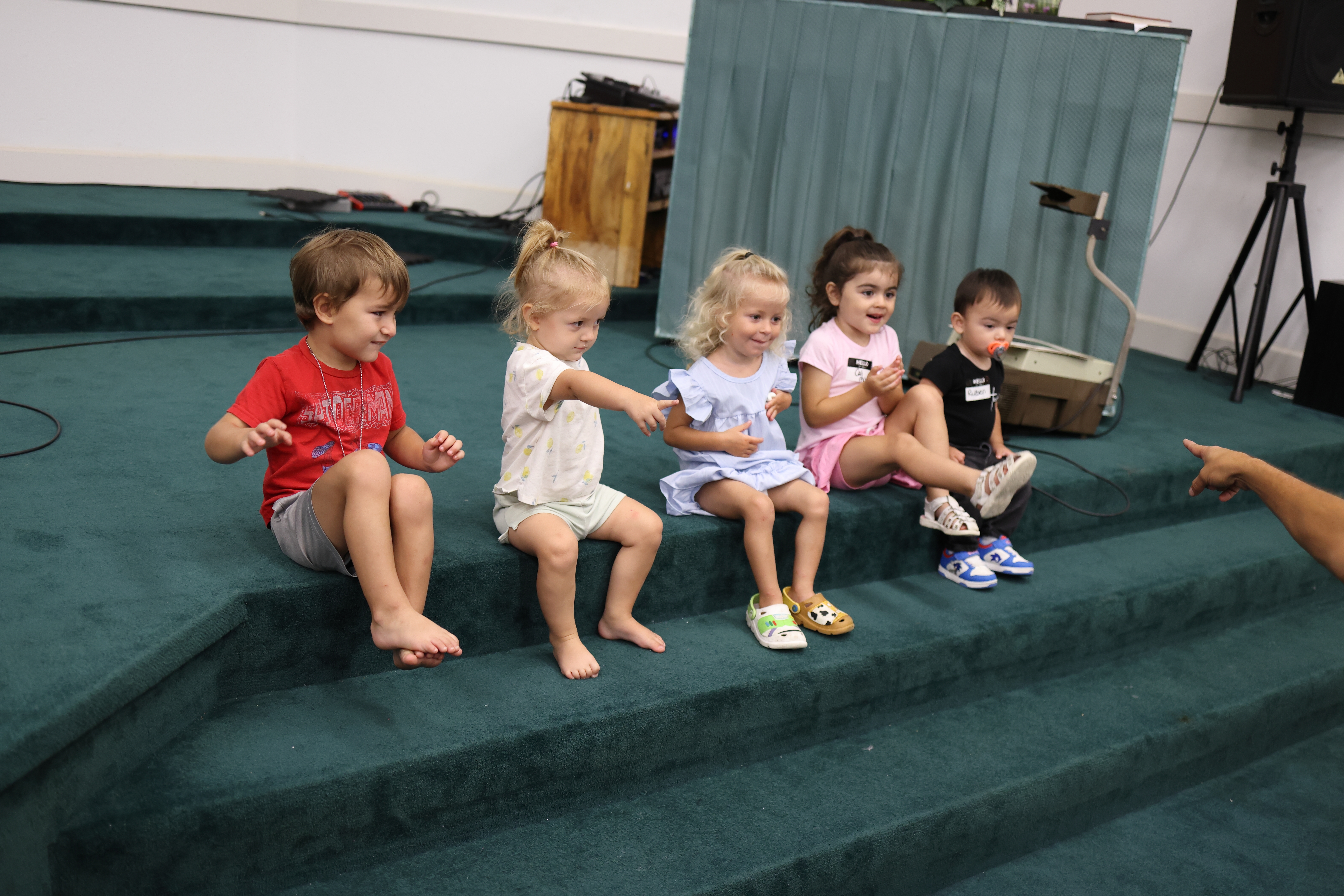 Twinland children sitting on the church steps